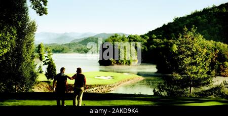 Friends playing golf on a golf course. Stock Photo