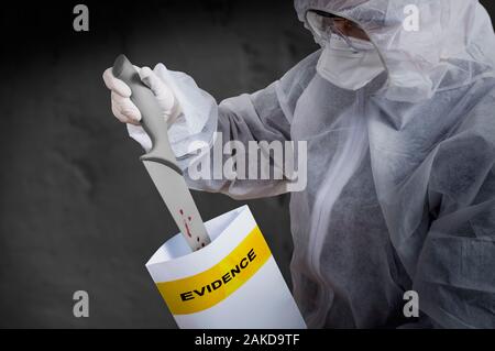 Forensic technician collecting evidence at crime scene, kitchen knife covered in blood, forensic science concept. Stock Photo
