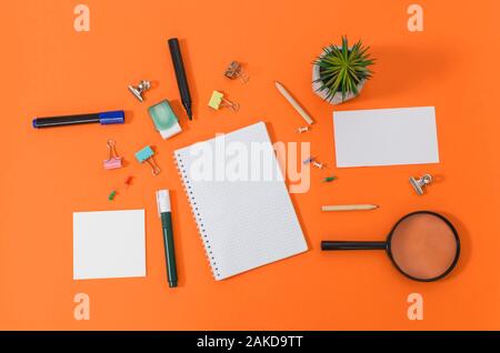 Close up office supplies on orange background, top of view Stock Photo