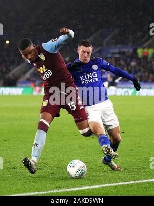 Aston Villa's Ezri Konsa (left) and Leicester City's Jamie Vardy battle for the ball during the Carabao Cup semi final first leg match at the King Power Stadium, Leicester. Stock Photo
