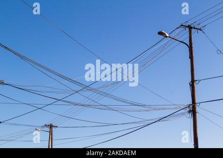 Electricity and telephone landline wires against blue sky, Hungary Stock Photo