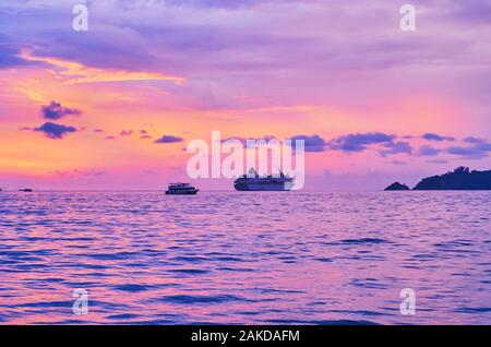 The purple sunset sky over Andaman sea with a view on cruise liner on horizon, Patong, Phuket, Thailand Stock Photo