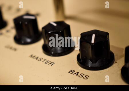 Close up of control knobs on an amp or amplifier for electric and bass guitars Stock Photo