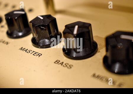 Close up of control knobs on an amp or amplifier for electric and bass guitars Stock Photo