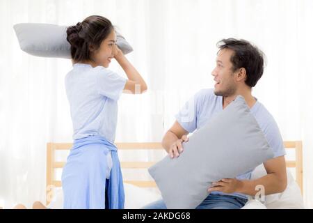 Asian young couple happy fun with playing pillow fight at bedroom, relationship of love concept. Stock Photo