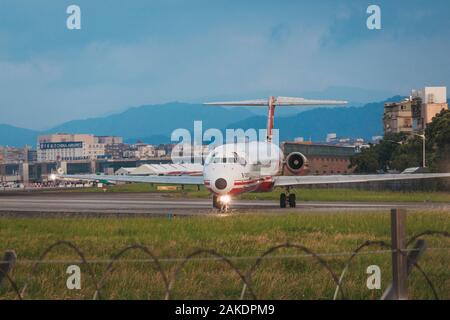 A Far Eastern Air Transport MD-82 prepares to depart Songshan Airport. The airline is now defunct Stock Photo