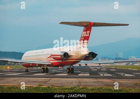 A McDonnell Douglas MD-83, of the now-defunct Far Eastern Air Transport, lines up for takeoff on Songshan Airport's runway one evening Stock Photo