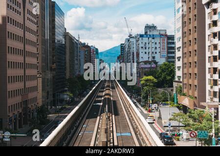 Looking down an elevated section of track as it goes between buildings, on Taipei Metro at Daan Station Stock Photo