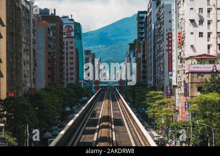 Looking down an elevated section of track as it goes between buildings, on Taipei Metro at Daan Station Stock Photo