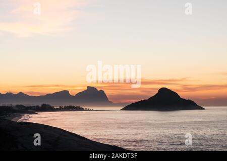 Golden dawn sunrise from Mirante do Roncador over Recreio Beach and the mountains of Rio de Janeiro.
