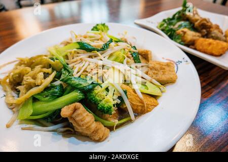 Plates of fried or boiled vegetables and mock meats boiled and fried at a vegetarian hot pot restaurant in Kaohsiung, Taiwan Stock Photo