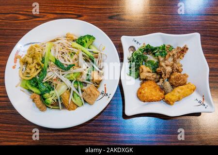 Plates of fried or boiled vegetables and mock meats boiled and fried at a vegetarian hot pot restaurant in Kaohsiung, Taiwan Stock Photo