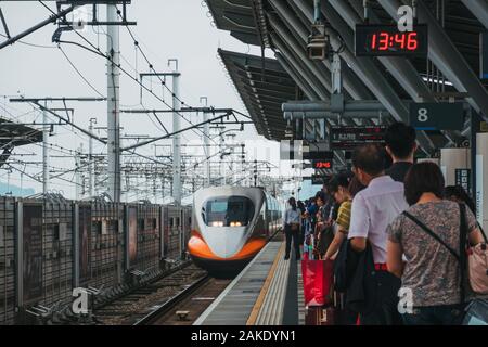 Passengers Wait On The Platform As A Taiwan High Speed Rail Bullet Train Arrives At Tainan Hsr Station Taiwan Stock Photo Alamy