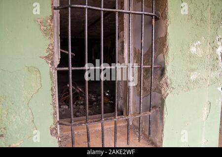 Steel bars blocking entrance of window in rustic dilapidated secured complex Stock Photo
