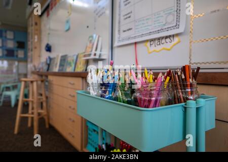 Movable art cart filled with various colored pencils in elementary school classroom Stock Photo