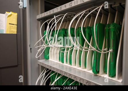 Rows of iPad tablets charging in storage case for grade school classroom students Stock Photo