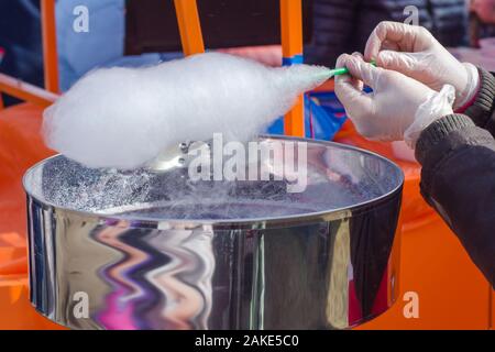 Girl making of the cotton candy at the fair Stock Photo