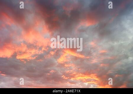 Dramatics sunset sky for background. Dramatic sunset sky with clouds glowing red. Stock Photo