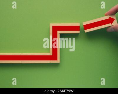 Busienss concept with wooden blocks and red arrow, growth or productivity concept Stock Photo