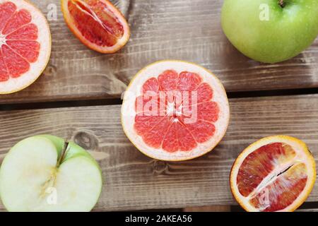 Mix of fresh sliced fruits on a wooden background. Photo with depth of field. Stock Photo
