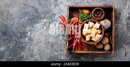 Feta cheese with herbs and garlic in bowl Stock Photo