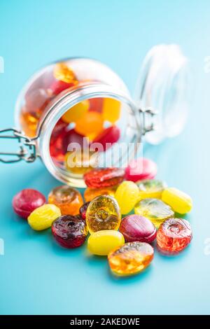 Sweet colorful candies on blue background. Stock Photo