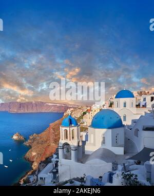 Sunset over the traditional Greek Orthodox churches of Oia (ia), Cyclades Island of  Thira, Santorini, Greece.  The settlement of Oia had been mention Stock Photo