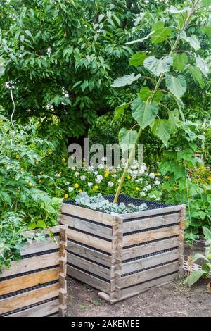 Wooden composter bin in a garden Stock Photo