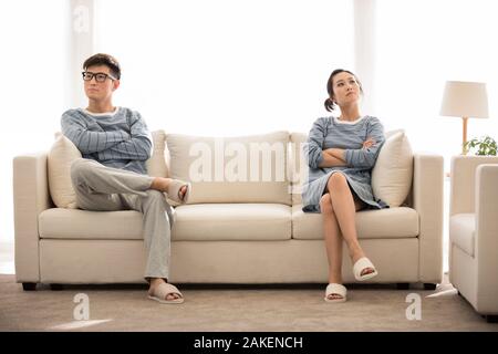 Young Chinese couple arguing in living room Stock Photo