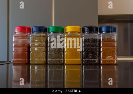 Set of various spices in bottles on the table Stock Photo