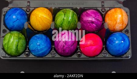 Plastic bowl full of colourful Easter eggs Stock Photo