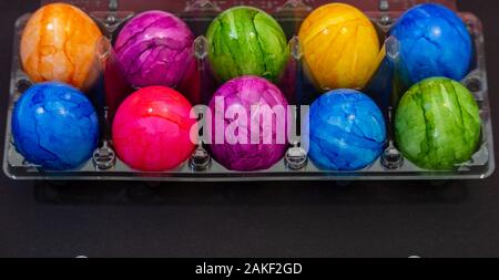 Plastic bowl full of colourful Easter eggs Stock Photo