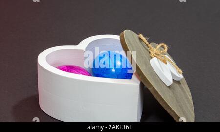 white wooden bowl with buten Easter eggs Stock Photo