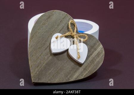 natural wooden lid with two white hearts on sisal run Stock Photo