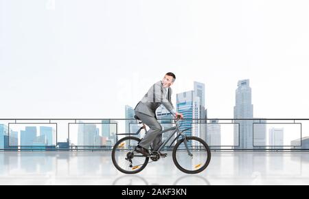 Man riding bicycle on penthouse balcony Stock Photo