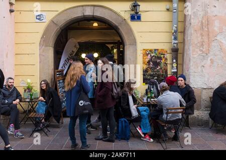 A crowd of young people at a popular bar in the old city of Krakow, Poland Stock Photo