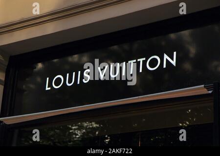 Street Signage Board with Louis Vuitton Logo in the Evening. Blurred  Business District Skyscrapers Background Editorial Image - Image of  evening, banner: 85967980