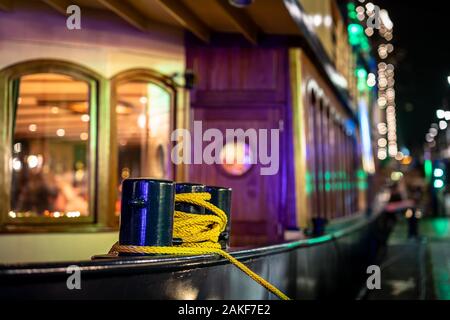 Bollard of a ship in the harbor with the bokeh of patches and colored lighting Stock Photo