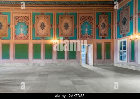 Beautiful elegant carved frames on green wall with ornate border and lanterns with white marble floor in old building Stock Photo