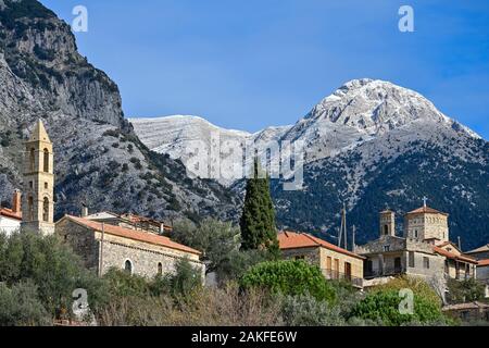 Looking across the church towers of Chora next to The Village of Exochori in the foothills of the Taygetos Mountains, with Chalasmeno Mountain in the Stock Photo