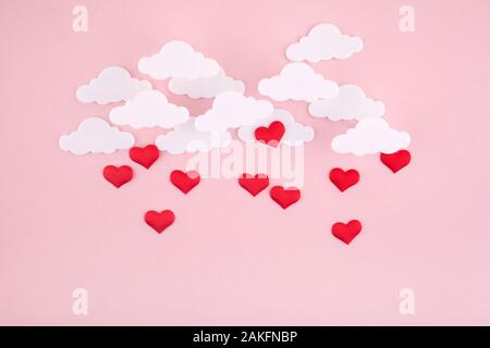 Valentine's day background. Red hearts and clouds on soft pink background feel like fluffy in the air Stock Photo