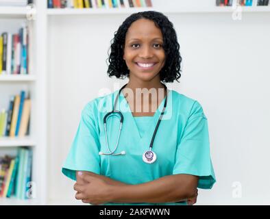 Laughing african american mature nurse at hospital Stock Photo