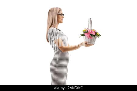 Blond woman holding a basket with flowers isolated on white background Stock Photo