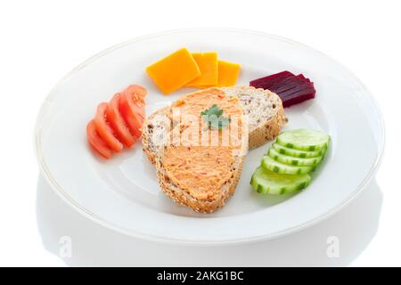 Two Sesame Bread Slices with Hummus Spread, Tomato, Cucumber and Cheese on a White Plate Stock Photo