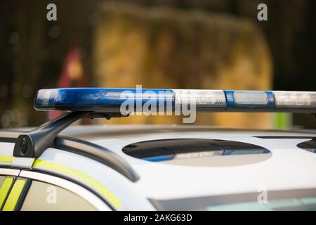 Close up of blue lights on roof light bar of isolated West Mercia police car.  UK police vehicle lights, emergency lights. Stock Photo