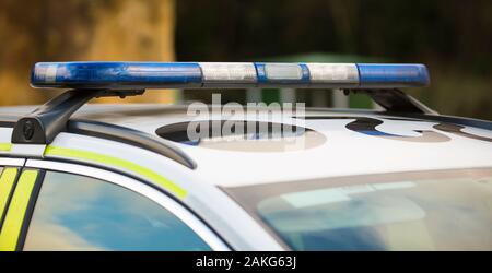 Close up of blue lights on roof light bar of isolated West Mercia police car.  UK police vehicle lights, emergency lights. Stock Photo