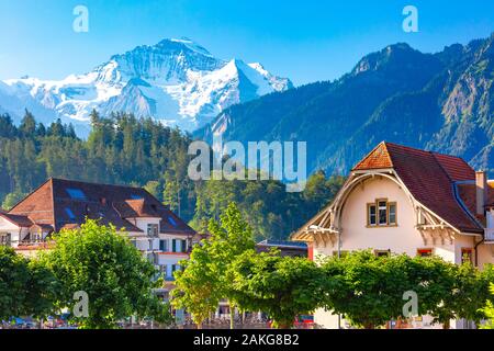 Houses in Old City of Interlaken, important tourist center in the Bernese Highlands, Switzerland. The Jungfrau is visible in the background Stock Photo