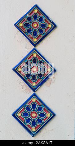 Three Tiles on Plaster Stock Photo