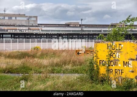 Close up of the passenger terminal in Berlin's old and abandoned Tempelhof airport, with a yellow panel with taxing instructions in the foreground Stock Photo