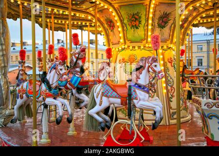 Colouful carousel horses on a traditional merry-go-round on Helsinki Christmas Market, Helsinki, Finland. Moderate Photoshop filtering applied. Stock Photo